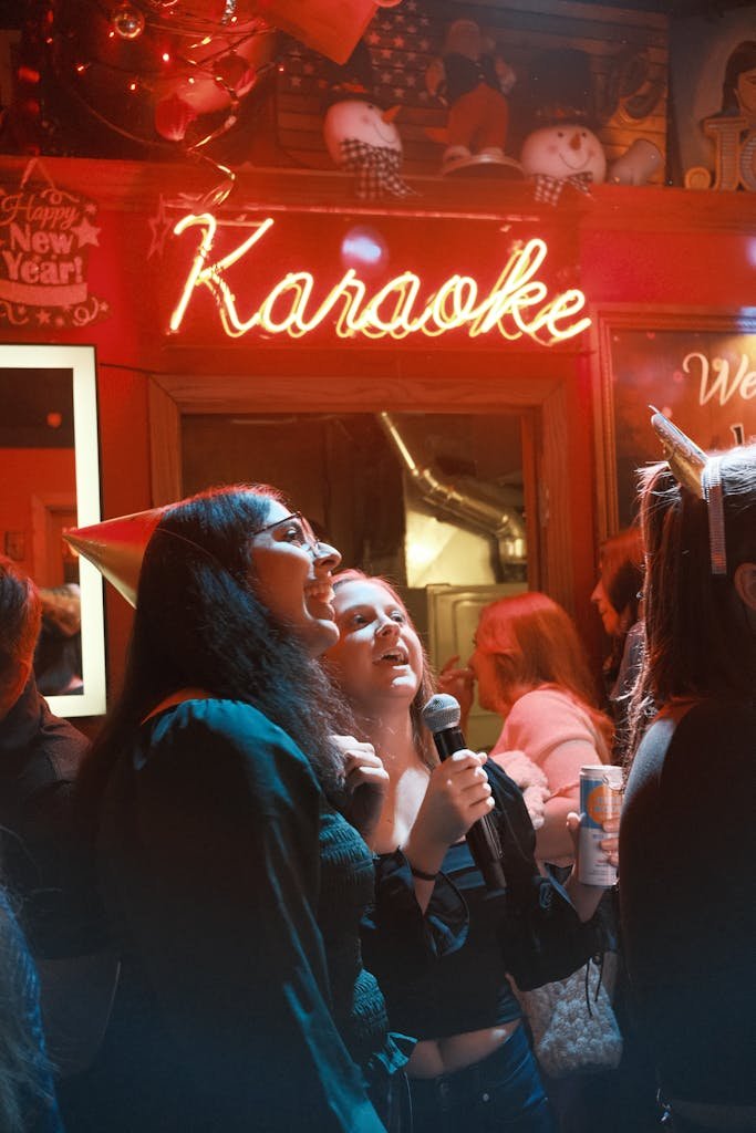 A group of friends enjoying karaoke at a lively New Year's Eve party.