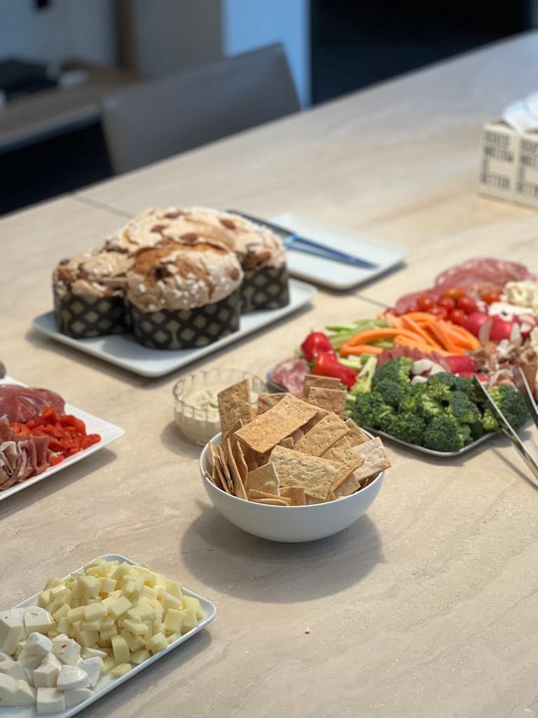 A table with a variety of appetizers and bread, perfect for gatherings.